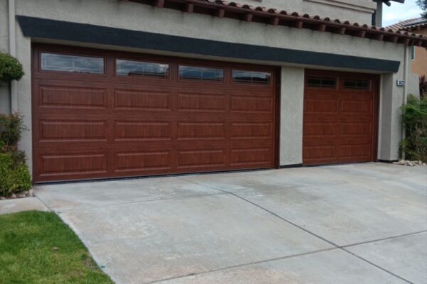 Two wood look garage doors installed on a residential home in Redlands, CA.