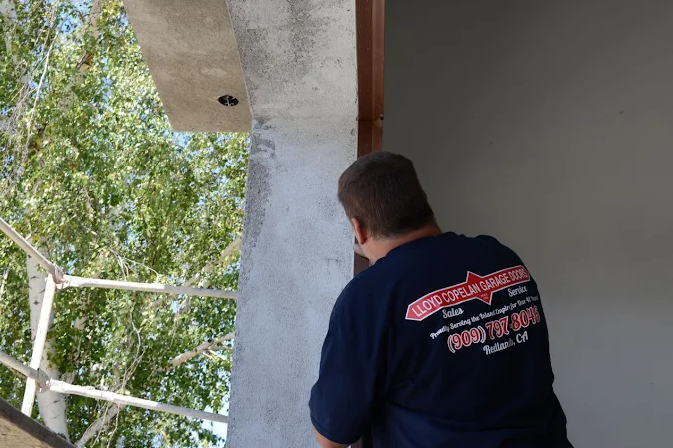 Lloyd Copelan Garage Doors technician working on a garage door installation at a home in Redlands, CA.