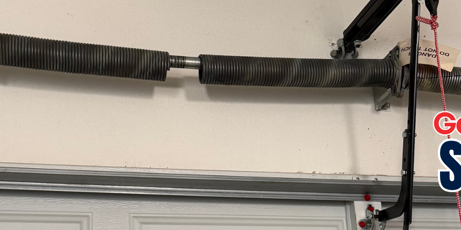 Broken torsion spring above a garage door with Lloyd Copelan Garage Doors service information