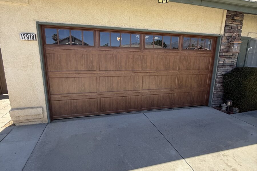After of a Yucaipa home garage door replacement featuring a Clopay Bridgeport door with Ultra-Grain finish by Lloyd Copelan Garage Doors.