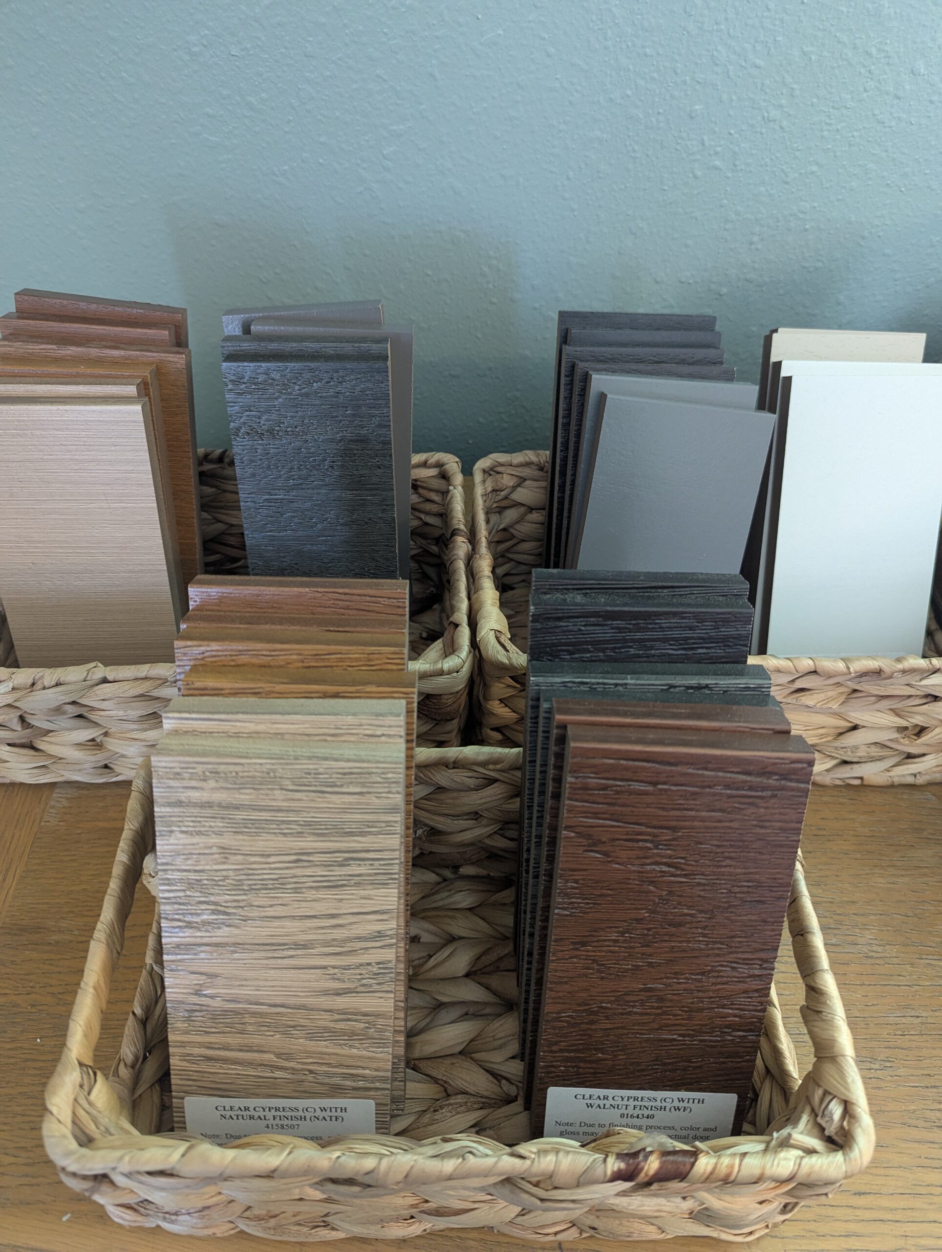 Baskets of real garage door color and woodgrain finish samples available to compare