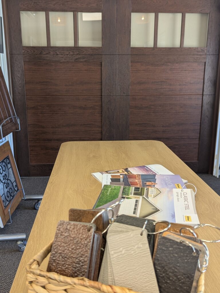 Garage door finish samples and brochures displayed in the Redlands showroom