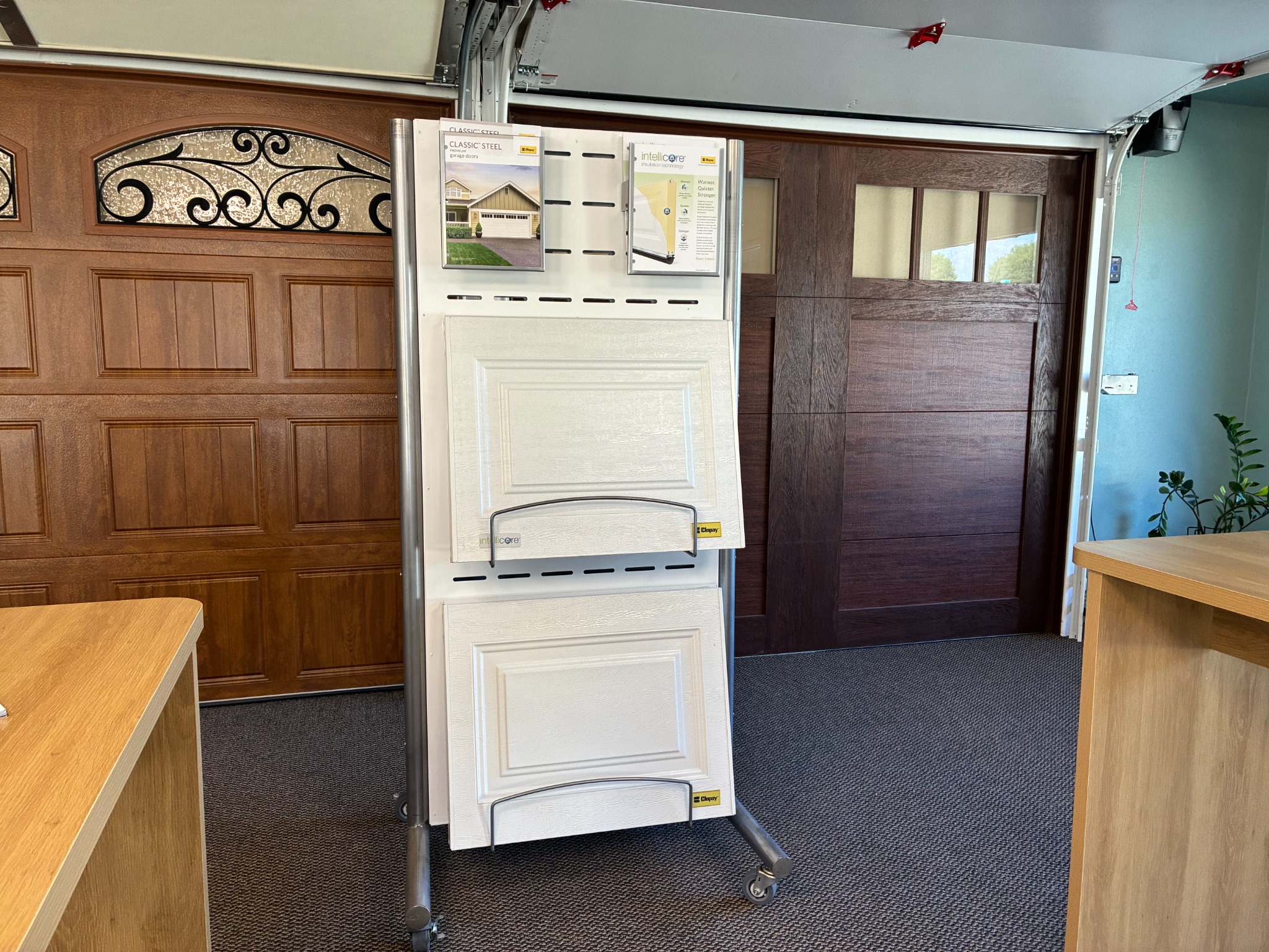 Garage door insulation sample display between full-size operating doors in the Lloyd Copelan showroom