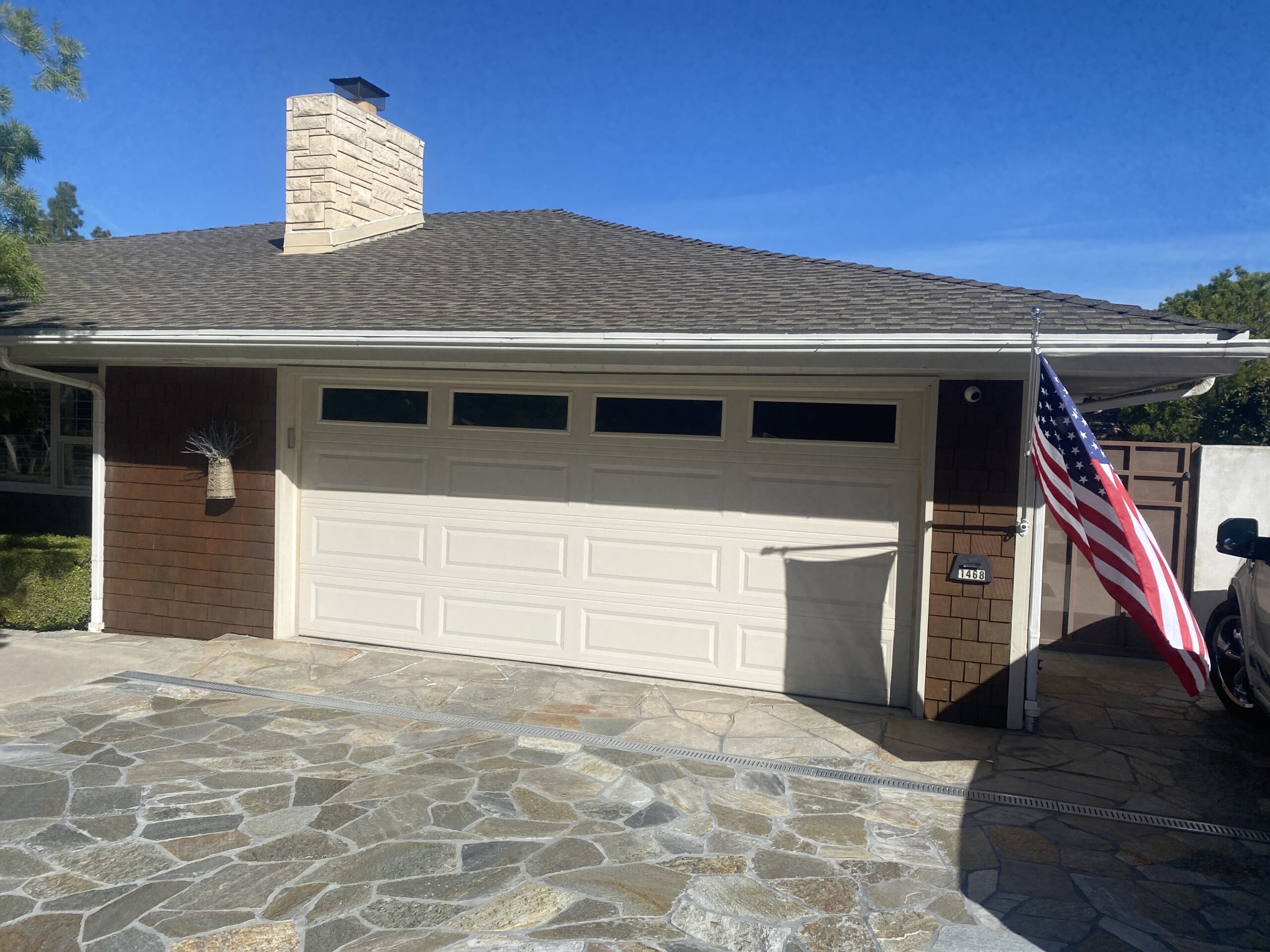 Before: existing garage door at a Redlands home ahead of a Premium Model 4310 replacement.