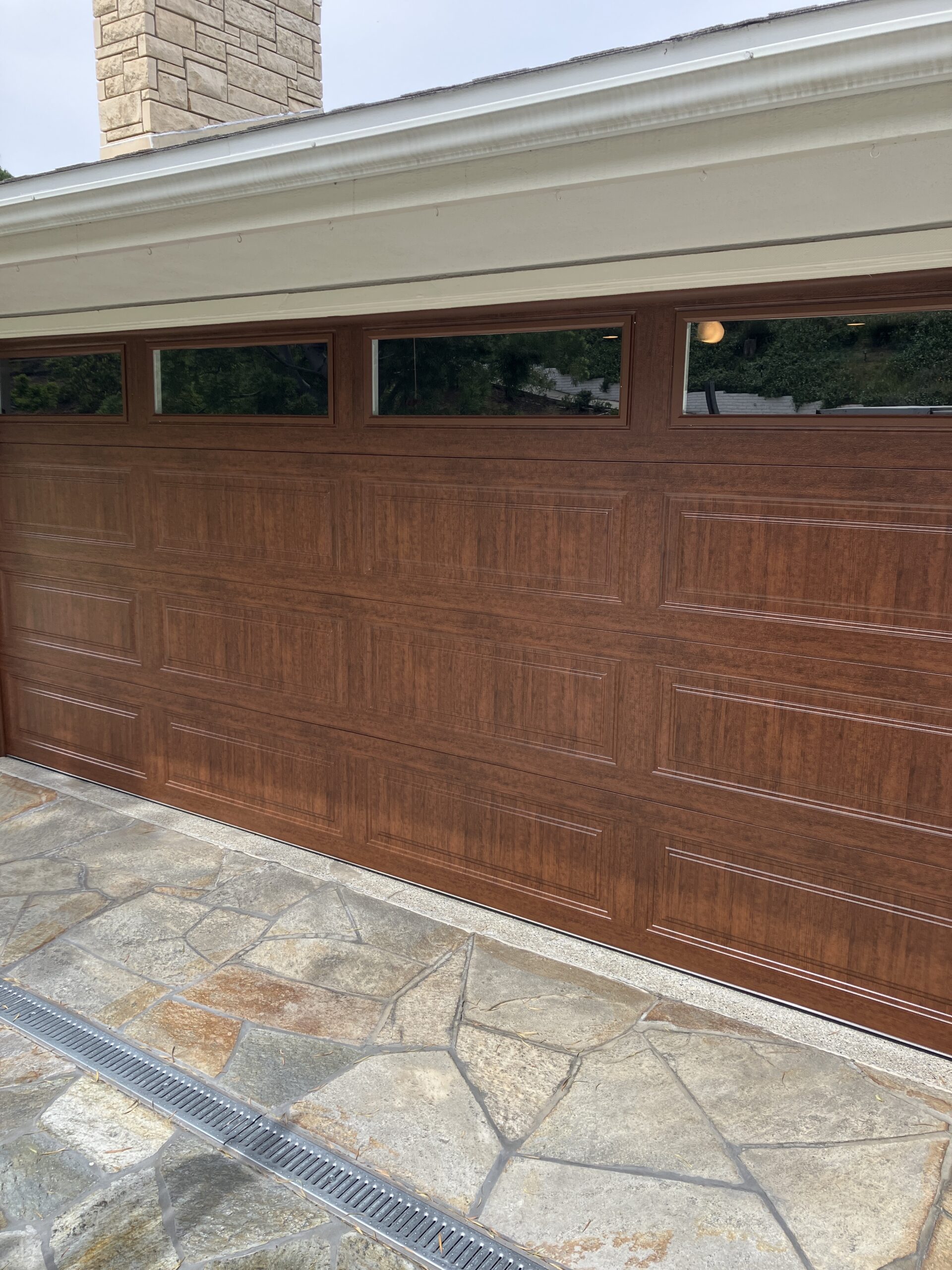 After: Classic Steel Premium Model 4310 garage door in Ultra-Grain Classic Walnut in Redlands.
