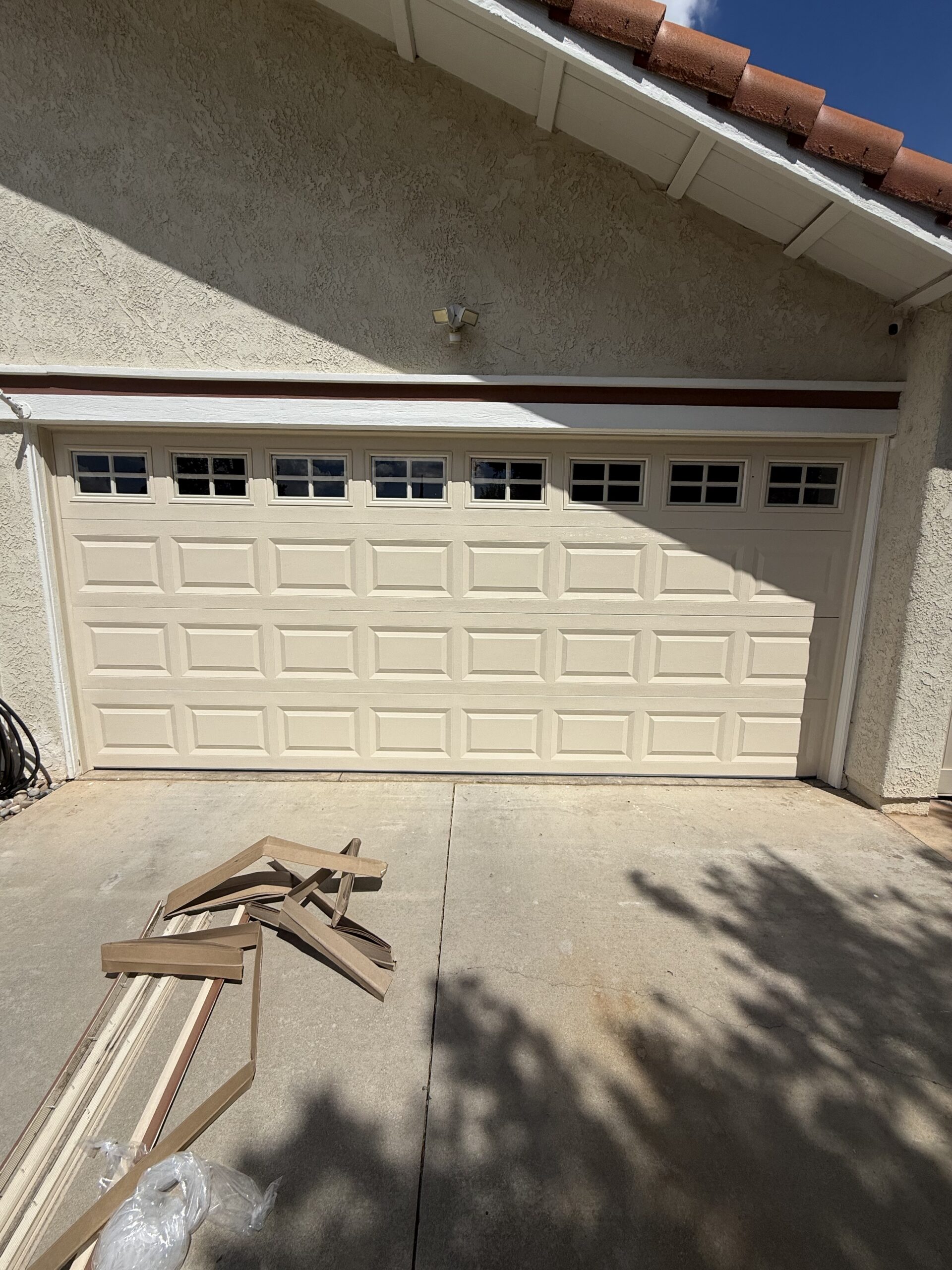 Classic Steel Value Plus garage door in Almond with Colonial windows in Redlands.