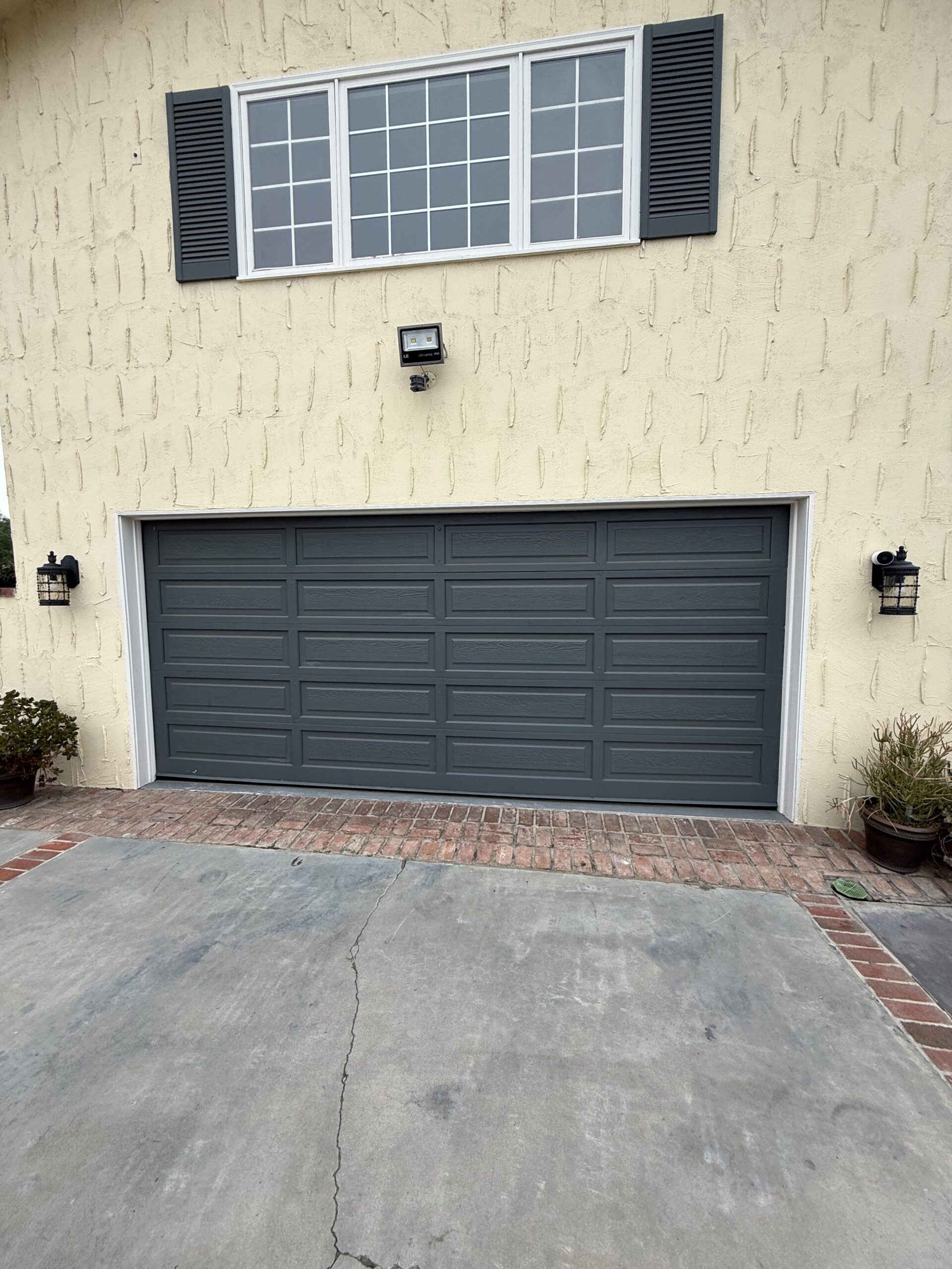 Before: existing garage door at a Redlands home ahead of an insulated Value Plus replacement.
