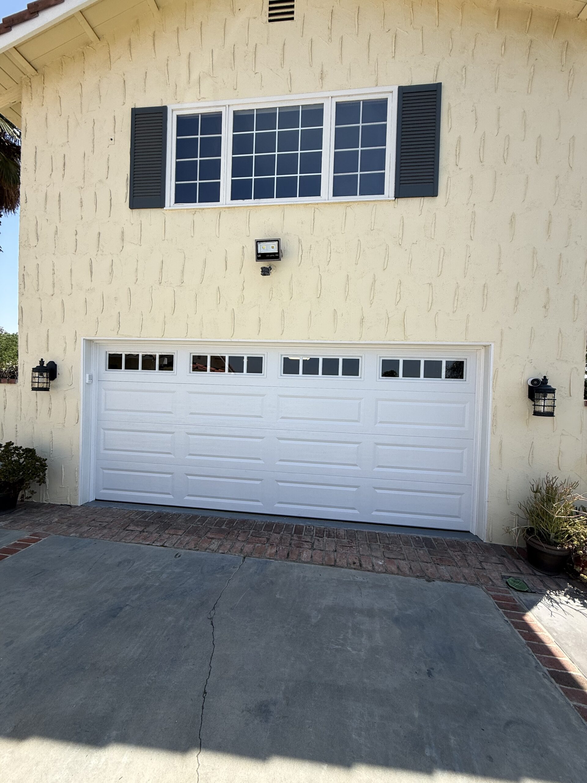 After: white Classic Steel Value Plus garage door with Long Panels and 611 windows in Redlands.
