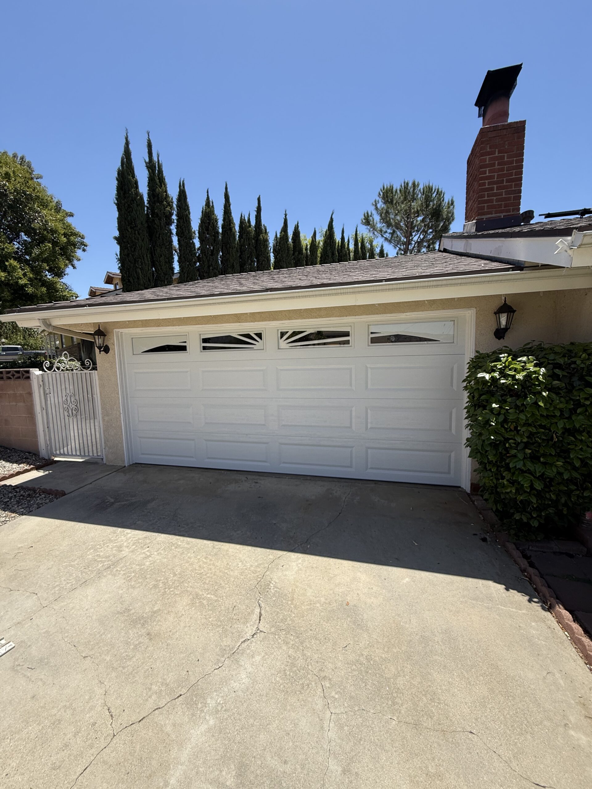 After: bright white Long Panel garage door at a Yucaipa home.